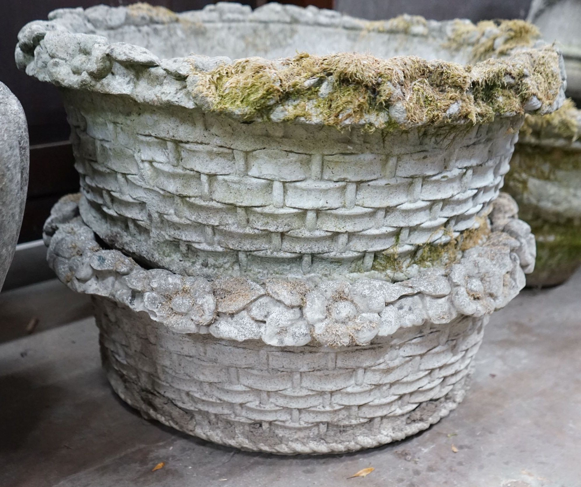 A pair of circular reconstituted stone floral basket garden planters, diameter 62cm, height 24cm